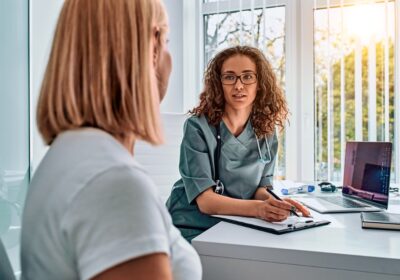doctor-woman-dressed-in-medical-suit-talking-in-office-reception-and-picture-id1366686044
