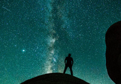 man-standing-on-rock-under-milky-way